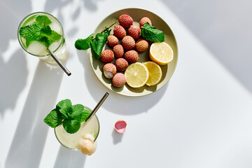 Refreshing lychee drink with lime, mint leaves and ice. Non-alcoholic sparkling cocktail fizzy drink perfect for summer hydration.