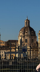 Fototapeta premium The stunning historical architecture of Rome features an intricately designed dome that beautifully contrasts with the clear blue sky, especially during the enchanting golden hour