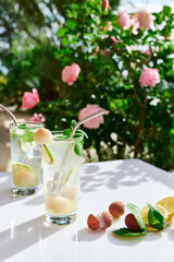 Refreshing lychee drink with lime, mint leaves and ice. Non-alcoholic sparkling cocktail fizzy drink perfect for summer hydration.