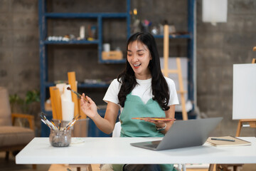 Artistic young woman working on a new painting.