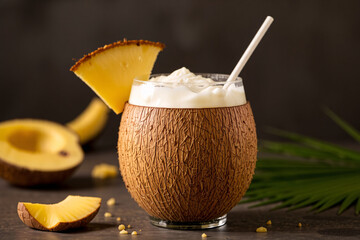 Creamy Pi&ntilde;a Colada served in a coconut shell, blending tropical flavors of coconut and pineapple.