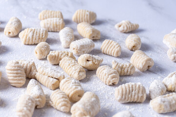 Counter full of raw gnocchi in preparation.