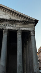 Naklejka premium Historical architecture of the Pantheon in Rome at twilight showcasing iconic columns and classical design elements