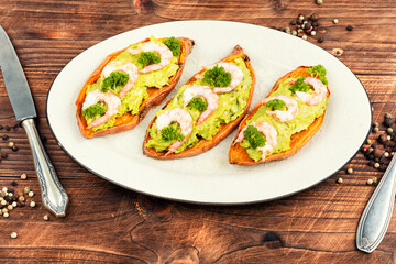 Sweet potato or yam with avocado and shrimp.
