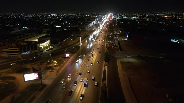 Camera drone flies ahead over night traffic on Khurais Road, Riyadh