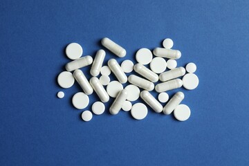 White pills on a colored background