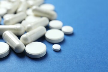 White pills on a colored background
