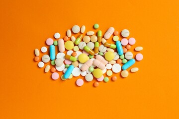 Various pills on a colored background
