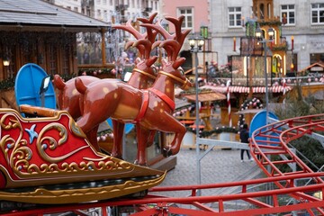 Carousel with decorative reindeer at a Christmas market © Nataliia