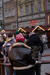 People wearing festive hats at a Christmas market