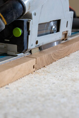 Close Up of Circular Saw Cutting Wood on Speckled Surface