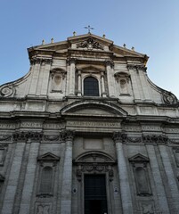 Historic church facade under clear blue sky in an urban setting showcasing intricate architecture and rich cultural details