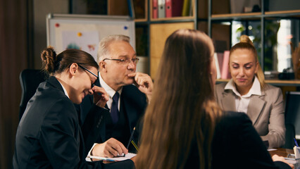Group of colleagues, men and women attending professional meeting with senior leader, presenting ideas and projects, working on strategies and ideas. Concept of business, teamwork