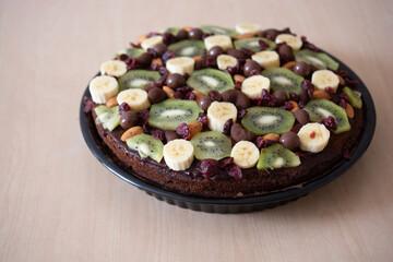 The dessert is decorated with fresh berries and fruits.