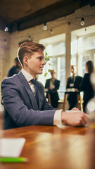 Young man, employee having personal conversation with leader in office settings. Proposing Ideas and professional development strategies. Concept of business, development, growth