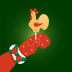 Woman's hand in red mitten holds  lollipop on a stick shaped like a cockerel.   Greeting card for Christmas and winter holidays. Vector illustration © Ann