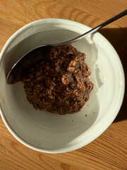 Chocolate oatmeal porridge on wooden table