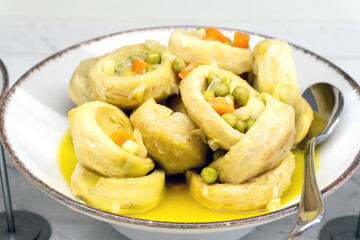Artichokes stewed with vegetables. Close-up.