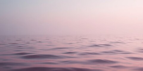 Obraz premium Serene Waters at Dawn A Gentle Ripple of Pink Hues Across the Misty Surface