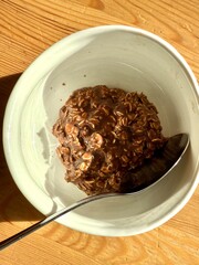 Chocolate oatmeal porridge on wooden table