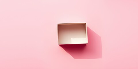Empty pink box on a pink background casting a shadow