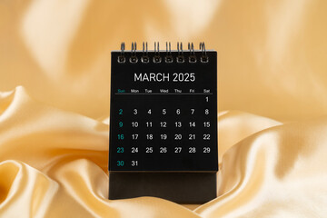 March Desk mini desk calendar black color for 2025 year on gold color silk.