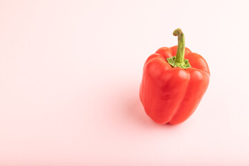 Red pepper on pink pastel, Side view, copy space.