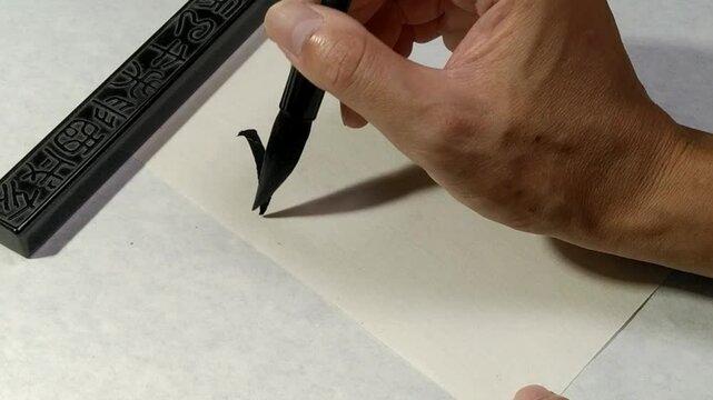 Writing Chinese Calligraphy on white paper, Translation: "Soft-living".