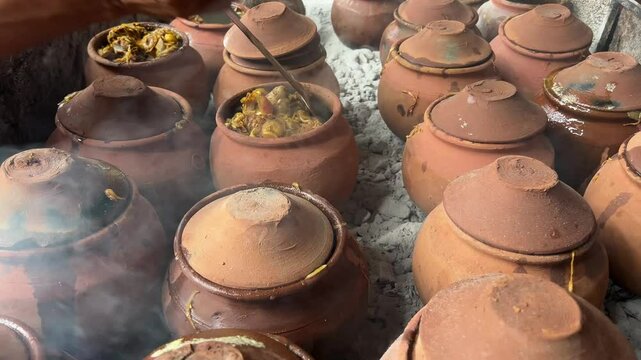Rows of earthen pot filled with mutton for Handi mutton preparation in Bihar.
