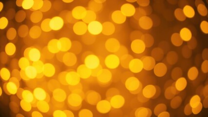 Obraz premium A golden bokeh background with out-of-focus circular lights creating a warm and festive atmosphere