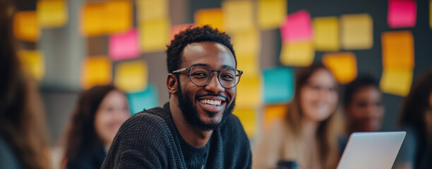 a cheerful person in a collaborative, colorful setting with the team suits campaigns on innovation and teamwork.