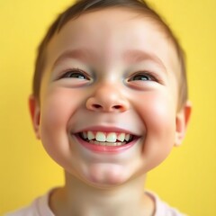 A joyful toddler beams a toothy grin against a sunny yellow backdrop. Pure happiness!
