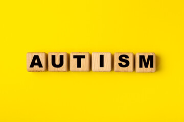 Autism awareness day.2 April world autism awareness day background.Design element.Care Awareness campaign for Autism.AUTISM text with colorful wooden puzzles, letters and cubes.Space for text.Top view