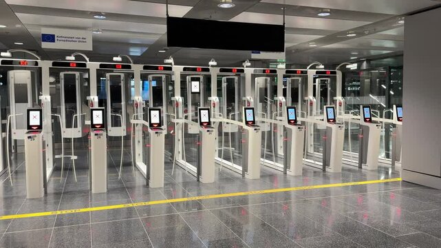 Zurich, Switzerland, December 15, 2024: PAN SHOT - Empty self-service e-Passport control at Swiss Airport Z&uuml;rich Kloten at night. Automated passport border control e-gates.