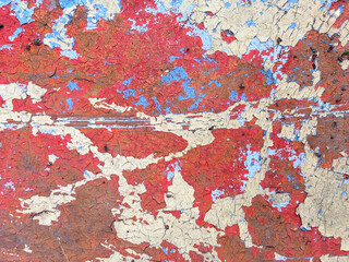 A wall with a lot of red and blue paint on it