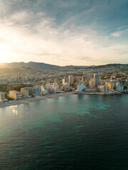 Naklejka premium Spectacular coastline of Calpe at sunset. Beautiful panoramic view of all region. Luxury urbanisations and Hotels. Famous travel destination in Alicante, Costa Blanca, Spain. Sunset point.