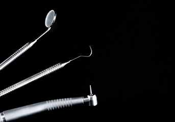 Dental tools on a black background close-up. Preparation of the dentist for the examination of the patient.