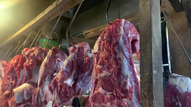 Hanging fresh meat in a traditional market.
