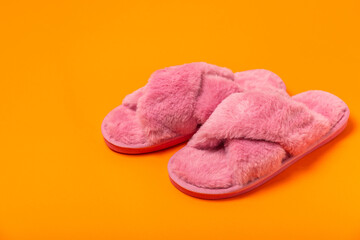 Soft slippers on a bright colored background, close-up. House slippers. Comfortable shoes for home. Foot care concept. Home comfort. Space for text. Copy space.