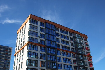 A very tall building with numerous windows set against a clear blue sky
