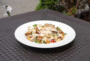 Caesar Salad, Green Lettuce Salat with Chicken and Parmesan Cheese Closeup