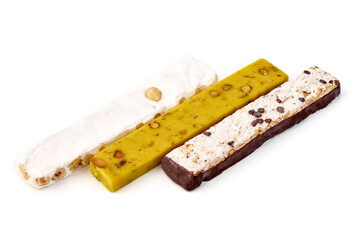 Three assorted nougat bars with hazelnuts and chocolate, isolated on white background.