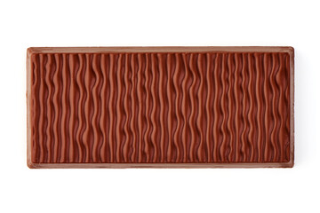 Milk chocolate bar with textured surface, isolated on white background.