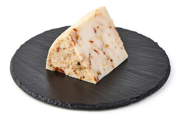 Piece of seasoned cheese with herbs, Primavera picante, isolated on white background.