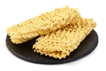 Instant noodles on a black slate plate, isolated on white background.