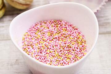 Bowl of pink sprinkles to decorate biscuits and cupcakes.