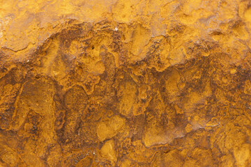 Unpolished rough yellow meteorite surface, abstract texture