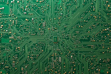 Close-up of green electronic circuit board with intricate pathways and components.