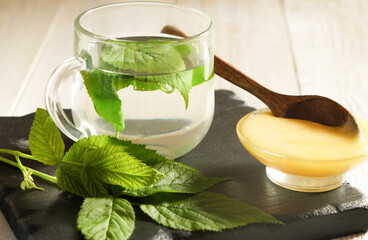 raspberry leaves Tea with Fresh Leaves and Honey on Slate Board