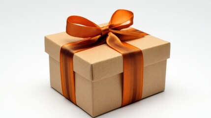 Obraz premium Stylishly Wrapped Brown Gift Box with Orange Ribbon for Celebrations, Birthdays, Holidays, and Special Occasions on a Soft Neutral Background